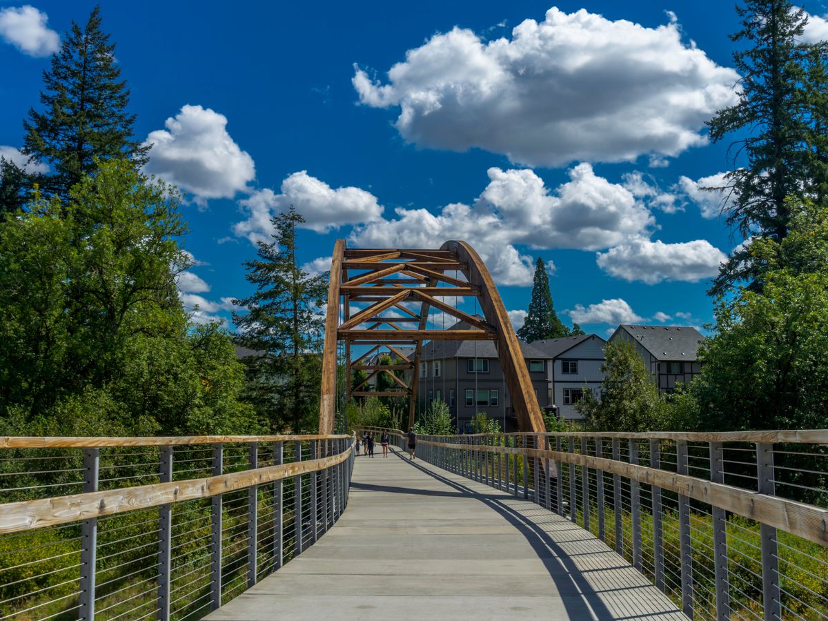 A walking bridge flanked by trees in Hillsboro, Oregon.