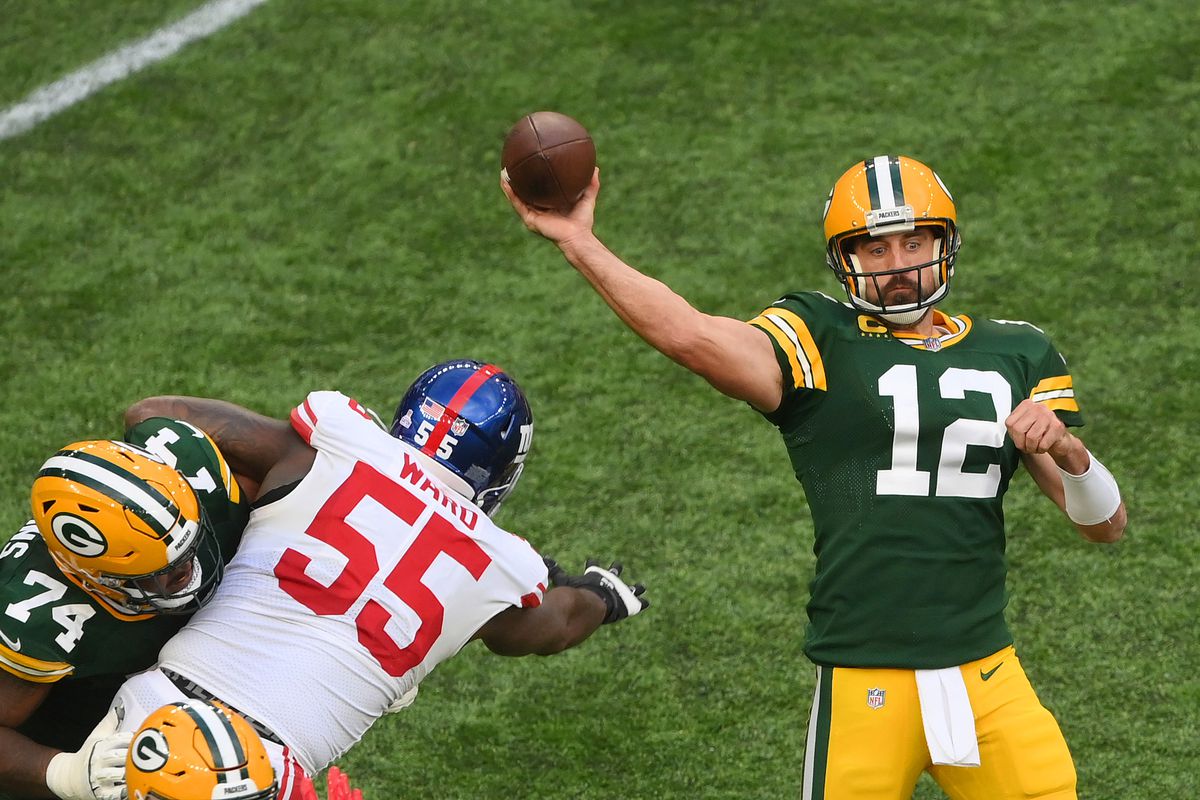 Aaron Rodgers #12 of the Green Bay Packers throws a pass in the second half during the NFL match between New York Giants and Green Bay Packers at Tottenham Hotspur Stadium on October 09, 2022 in London, England.