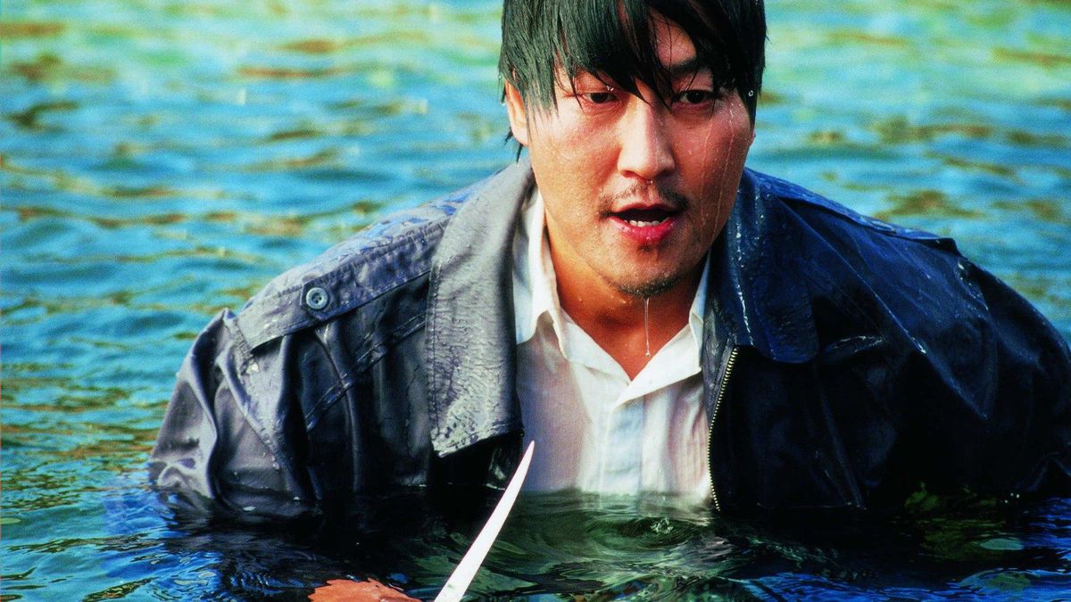 Kang-ho Song as Dong-jin Park holding a knife and drenched in water in Sympathy for Mr. Vengeance.