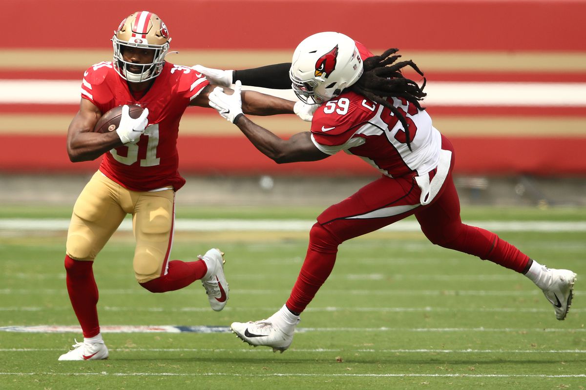 Raheem Mostert of the San Francisco 49ers is tackled by De’Vondre Campbell #59 of the Arizona Cardinals at Levi’s Stadium on September 13, 2020 in Santa Clara, California.  