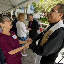 Corinne Anderson, unity clerk in the neonatal intensive care unit at St. Mark's Hospital in Millcreek, talks with the Rev. Javier G. Virgen, of the Catholic Diocese of Salt Lake City, after the 18th annual Blessing of the Hands at the hospital on Monday, May 13, 2019. The annual ceremony, featuring spiritual leaders from different denominations, recognizes hospital employees for all that they do to promote healing and provide comfort for patients throughout the year.