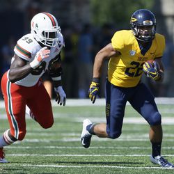 Toledo running back Bryant Koback (22) is pursued by Miami defensive lineman Joe Jackson (99) during the second half of an NCAA college football game Saturday, Sept. 15, 2018, in Toledo, Ohio. Miami defeated Toledo 49-24. 