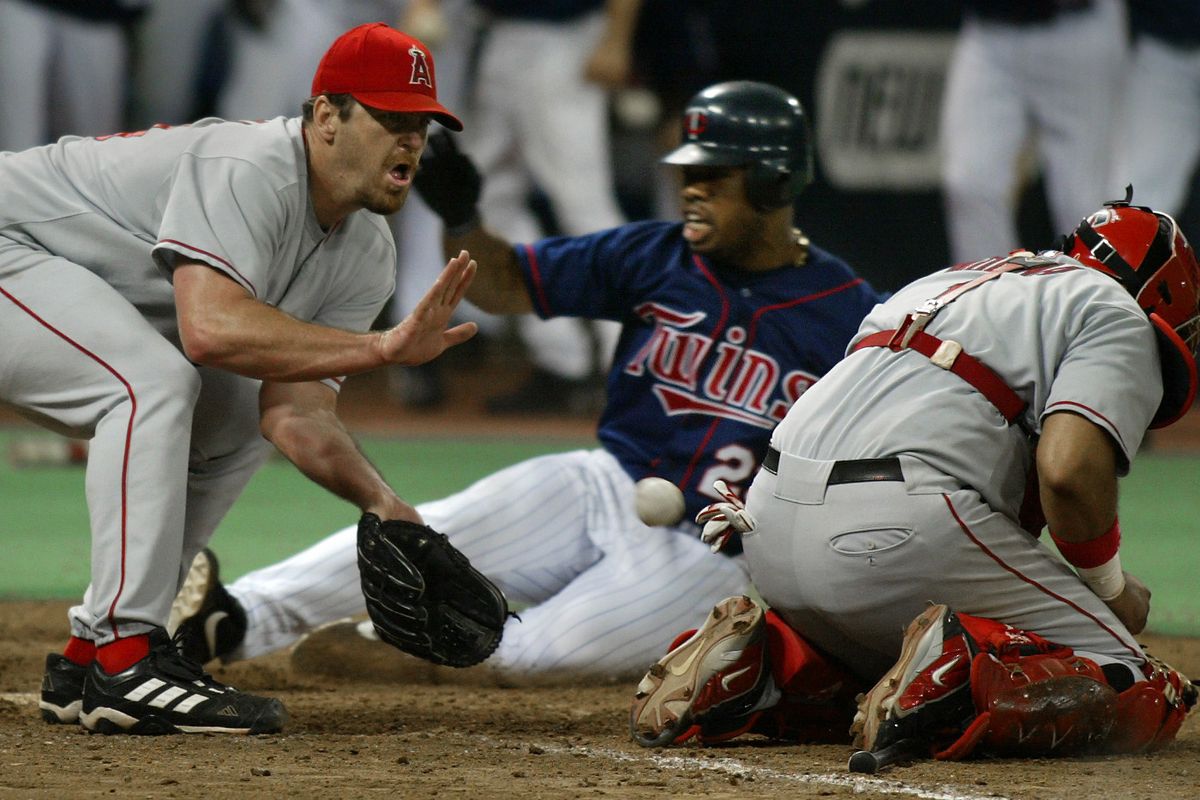 Minneapolis, MN., Wednesday, 9/3/2002. (left to right) Angels Pitcher Troy Percival covered home plate as Minnesota Twins Shannon Stewart scored sliding past an injured Anaheim catcher Bengie Molina to win the game. Stewart scored after hitting an in t