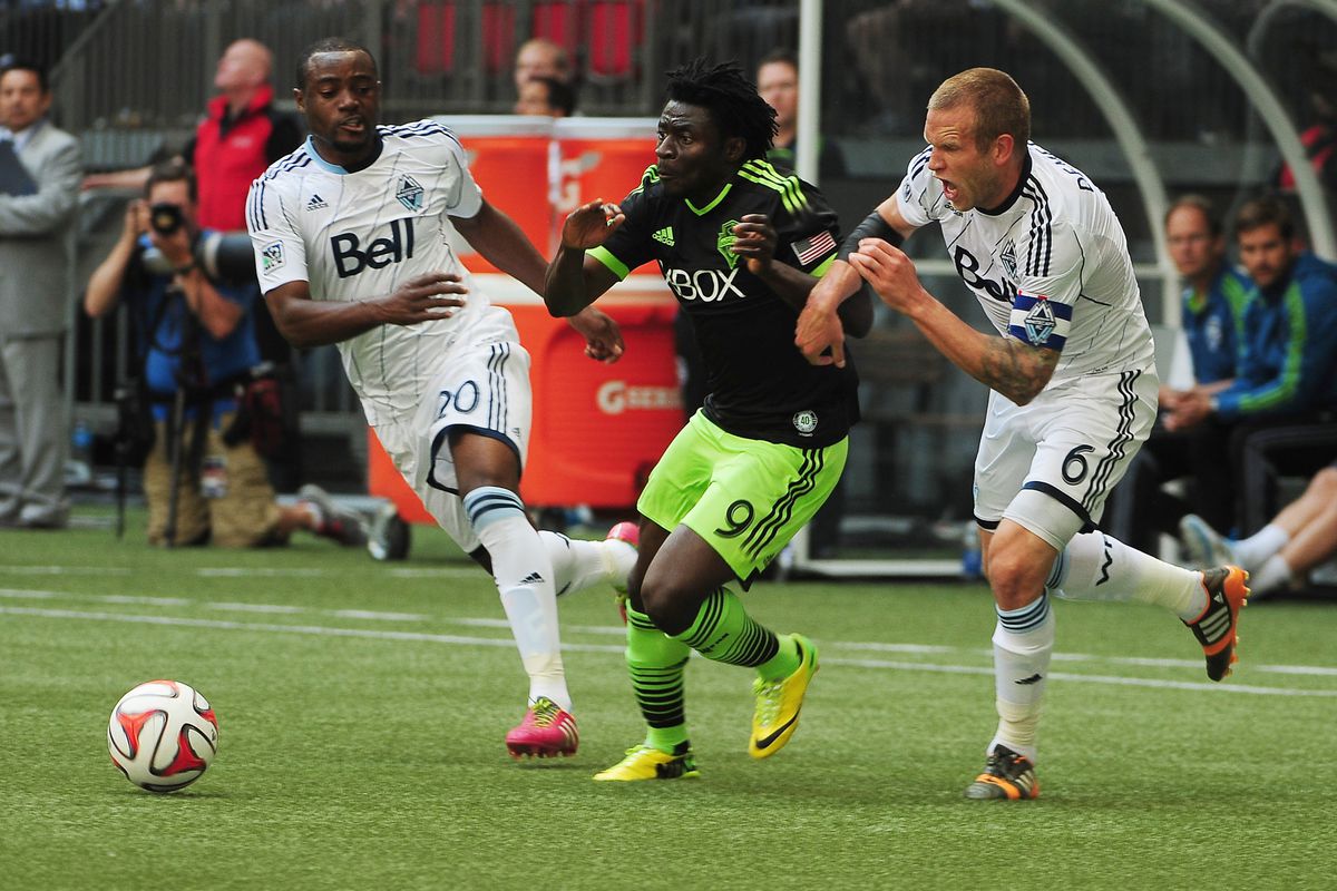 As he defends Seattle's Obafemi Martins, Jay DeMerit shows slightly less anger than he did when the game-deciding penalty call was given.