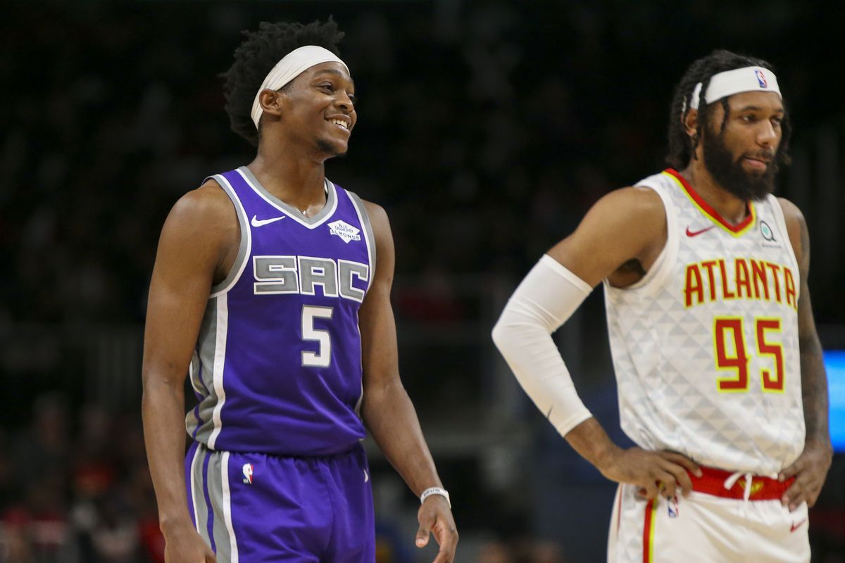 Sacramento Kings guard De’Aaron Fox and Atlanta Hawks guard DeAndre’ Bembry on the court in the third quarter at State Farm Arena.