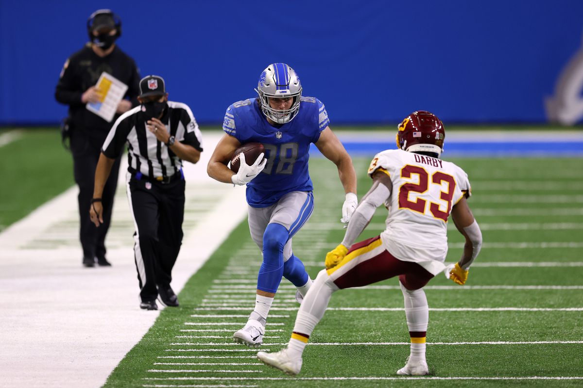 T.J. Hockenson #88 of the Detroit Lions attempts to run with the ball against Ronald Darby #23 of the Washington Football Team during their game at Ford Field on November 15, 2020 in Detroit, Michigan.