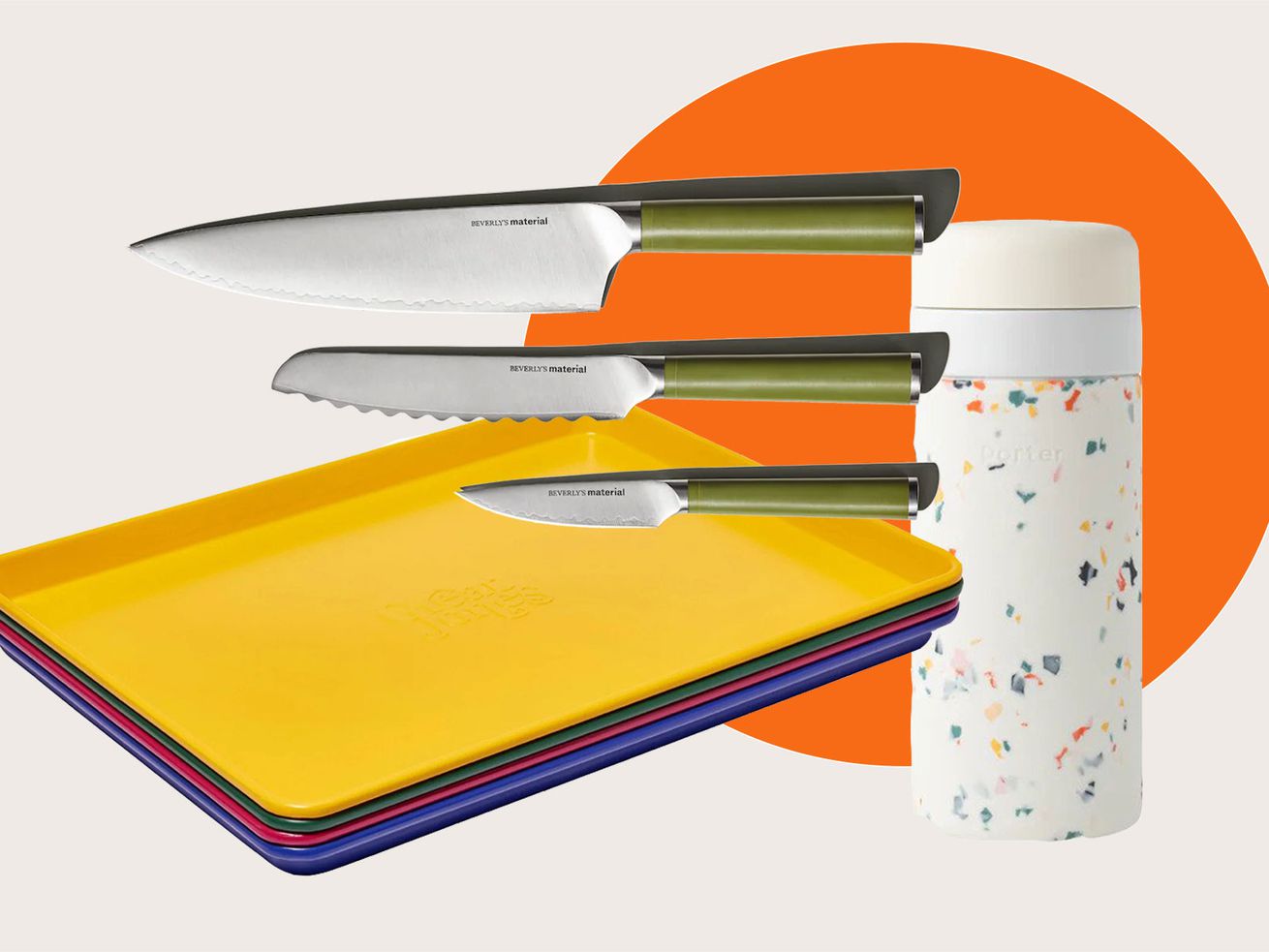 A trio of knives, stacked sheet pans in various colors, and an insulated cup