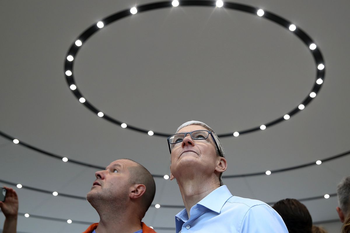 Apple CEO Tim Cook and Apple chief design officer Jonathan Ive look up at the circular ceiling as they tour the display area during an Apple special event at the Steve Jobs Theater on the Apple Park campus on September 12, 2017.