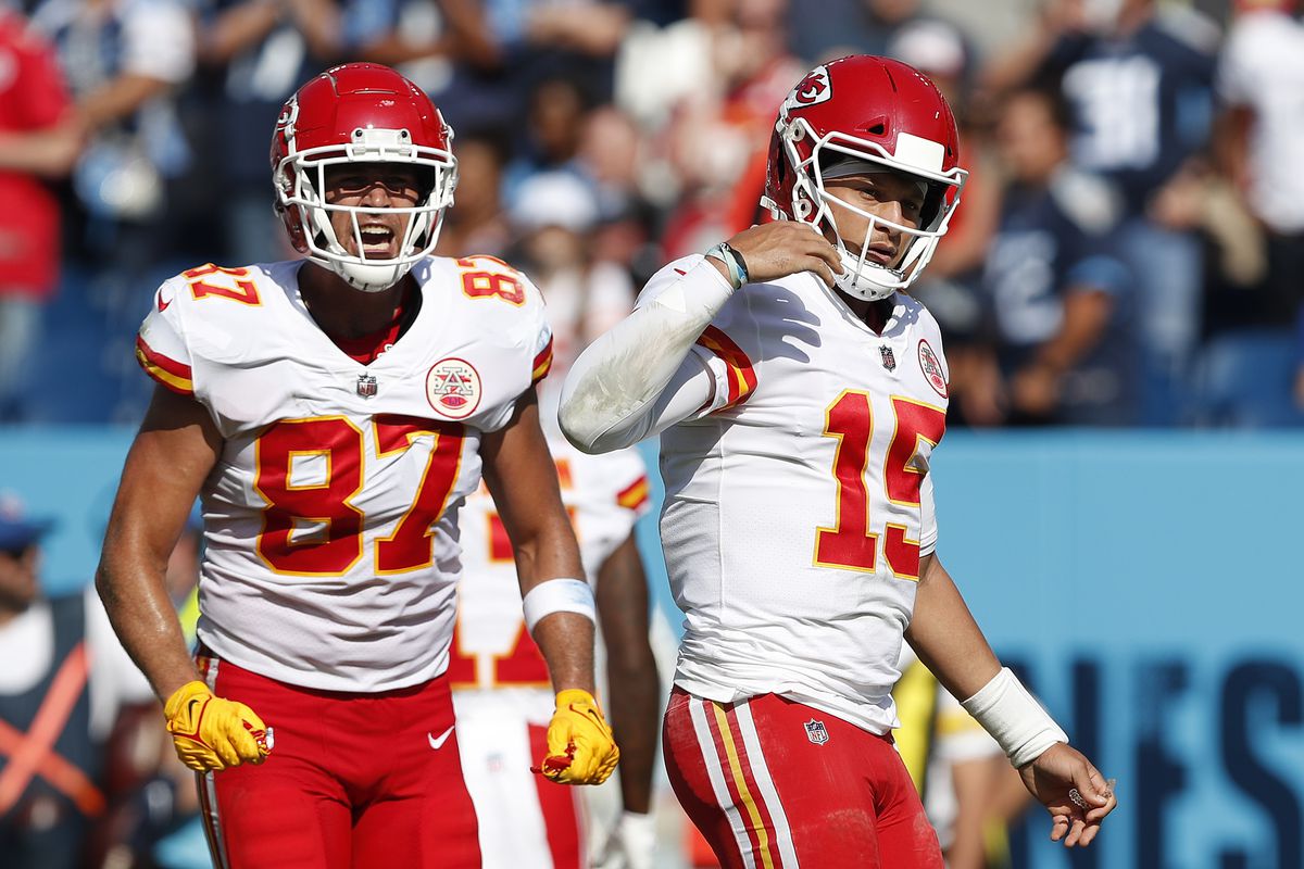 Travis Kelce #87 and Patrick Mahomes #15 of the Kansas City Chiefs react against the Tennessee Titans in the game at Nissan Stadium on October 24, 2021 in Nashville, Tennessee.