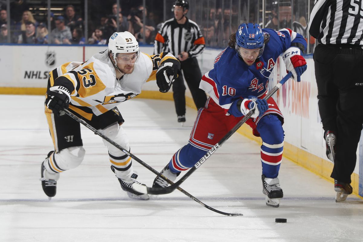Artemi Panarin #10 of the New York Rangers skates the puck past Teddy Blueger #53 of the Pittsburgh Penguins during the third period in Game Seven of the First Round of the 2022 Stanley Cup Playoffs at Madison Square Garden on May 15, 2022 in New York City.
