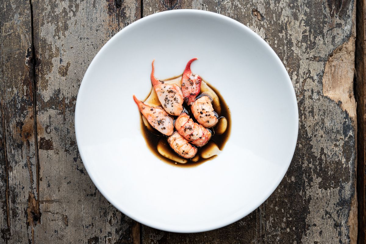 Crayfish on a white plate on a wood background at Silo London