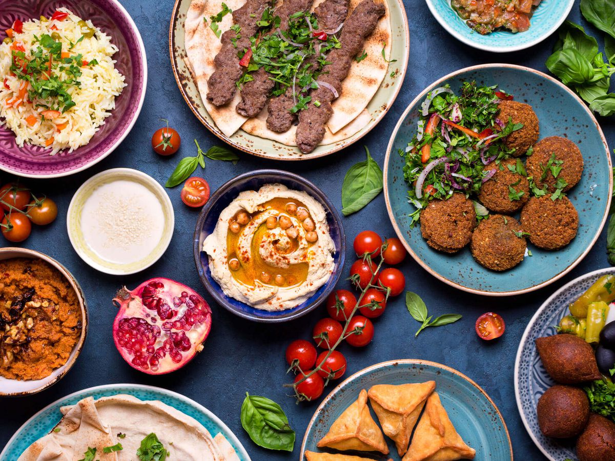 A top-down spread of falafel, kababs, hummus, and other Syrian specialties