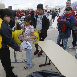 Security guards take tickets and search coats and bags as fans enter the stadium to watch Real Salt Lake and Chivas USA play Saturday, April 20, 2013 at Rio Tinto Stadium.