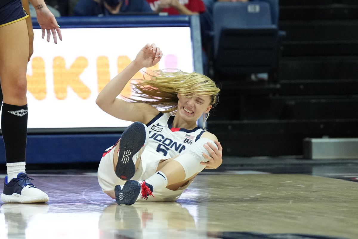 UConn Huskies guard Paige Bueckers (5) holds her knee on her way to the ground in the second half against the Notre Dame Fighting Irish at Harry A. Gampel Pavilion.