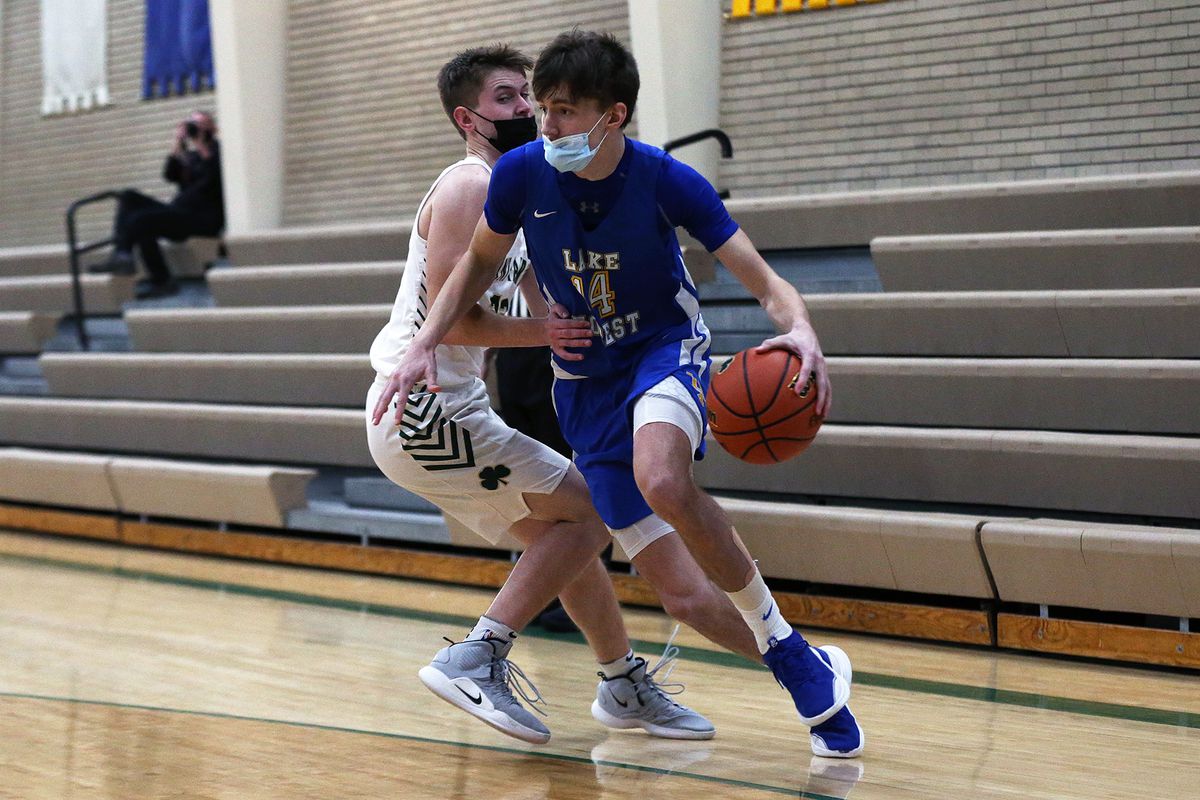Lake Forest’s Asa Thomas (14) dribbles around a St. Pat’s defender.