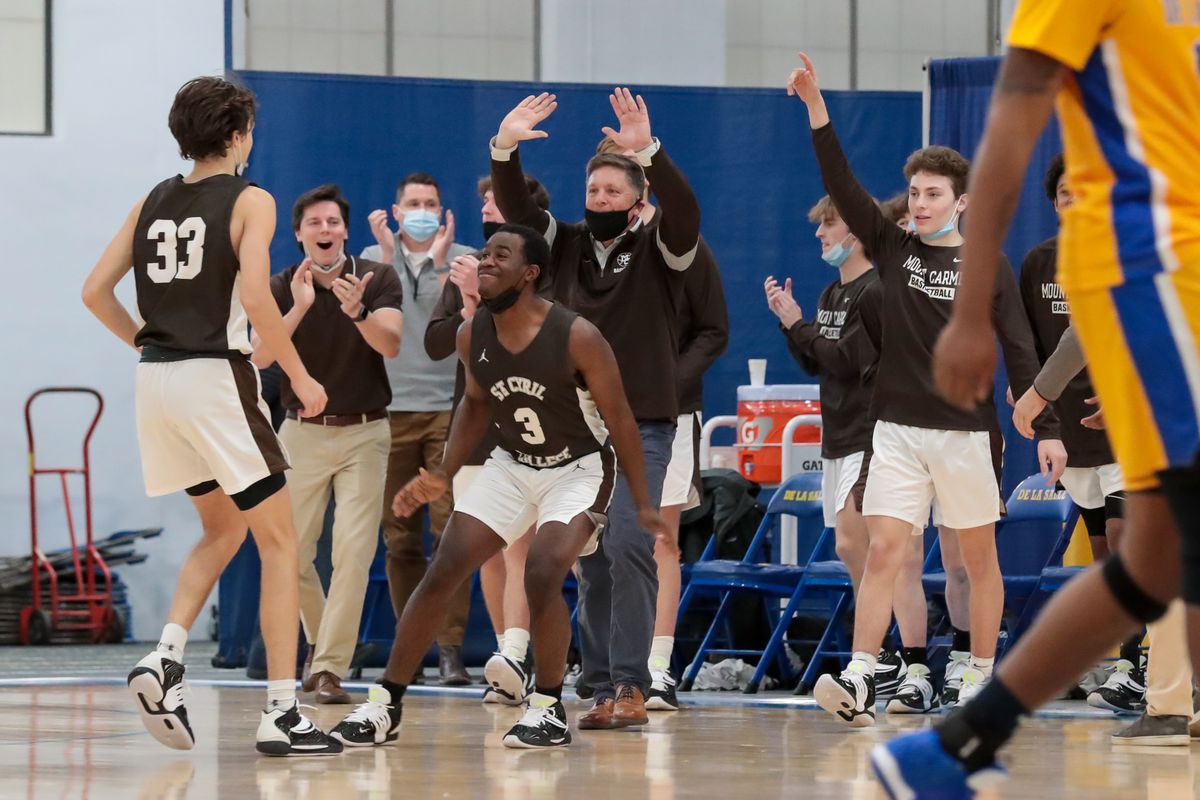 Mount Carmel players and coaches react after winning the game against De La Salle.
