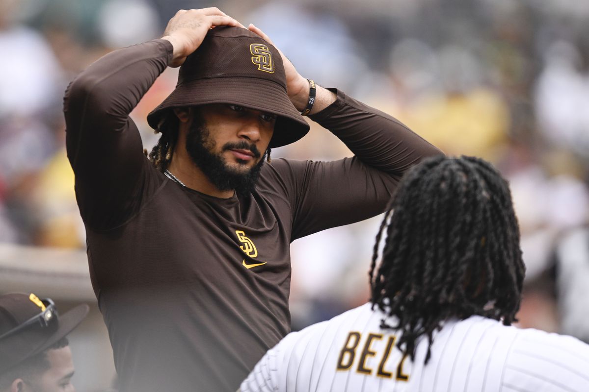 Fernando Tatis Jr. #23 of the San Diego Padres talks with Josh Bell #24 during a baseball game against the Colorado Rockies August 4, 2022 at Petco Park in San Diego, California.