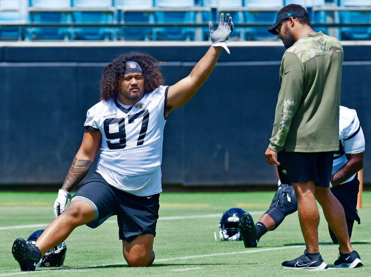 Jacksonville Jaguars associate strength coach Kevin Maxen works with defensive tackle Jay Tufele during the Jaguars rookie minicamp session in June 2022.