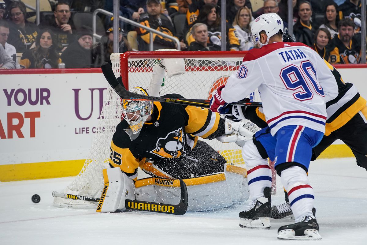 Pittsburgh Penguins Goalie Tristan Jarry makes a save on Montreal Canadiens Left Wing Tomas Tatar in front during the third period in the NHL game between the Pittsburgh Penguins and the Montreal Canadiens on February 14, 2020, at PPG Paints Arena in Pittsburgh, PA.