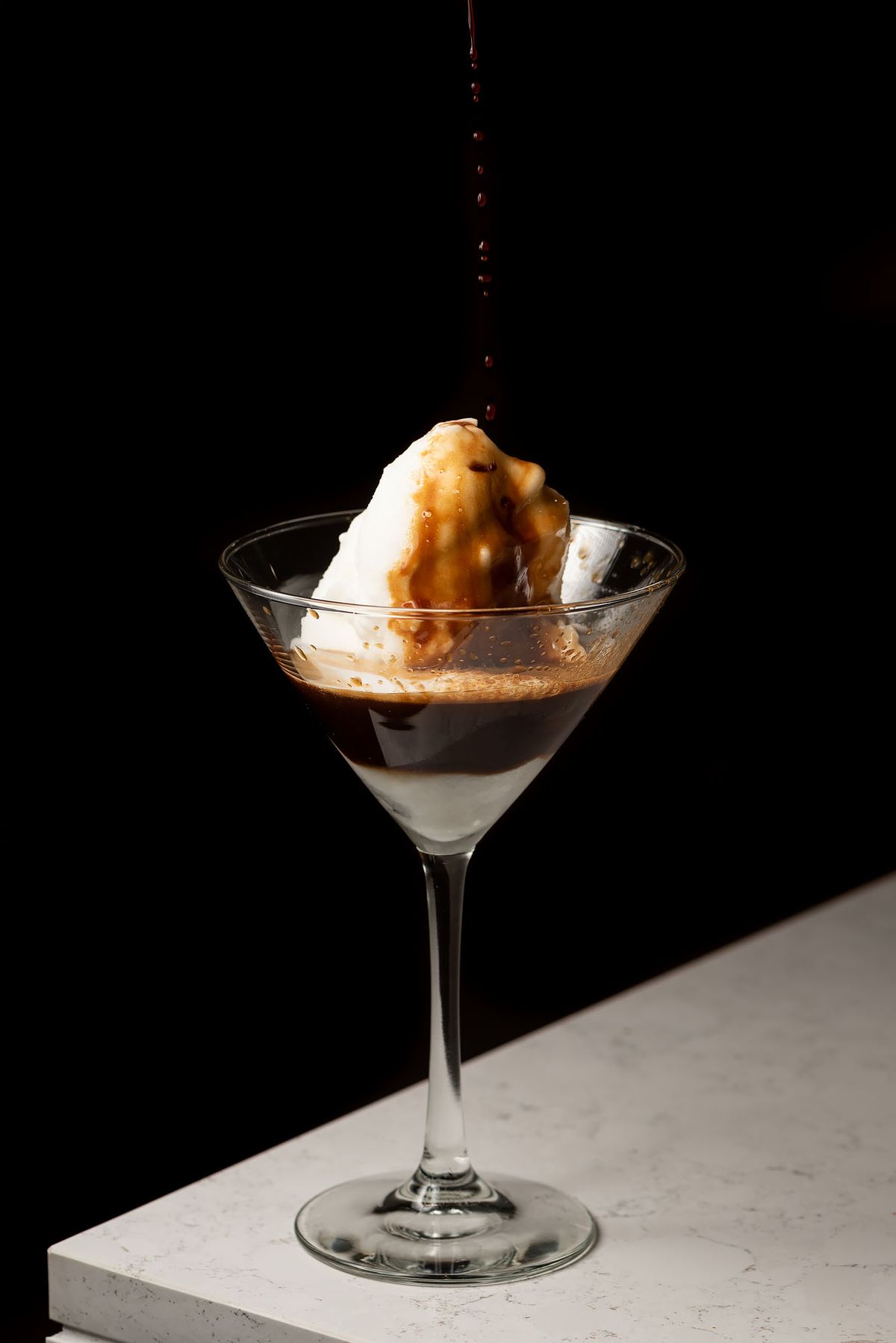 A gelato affogato in a martini glass.