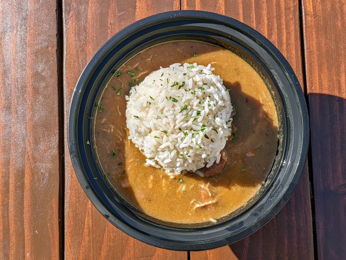 Gumbo with rice at Nola Creole and Cajun against a wood table.