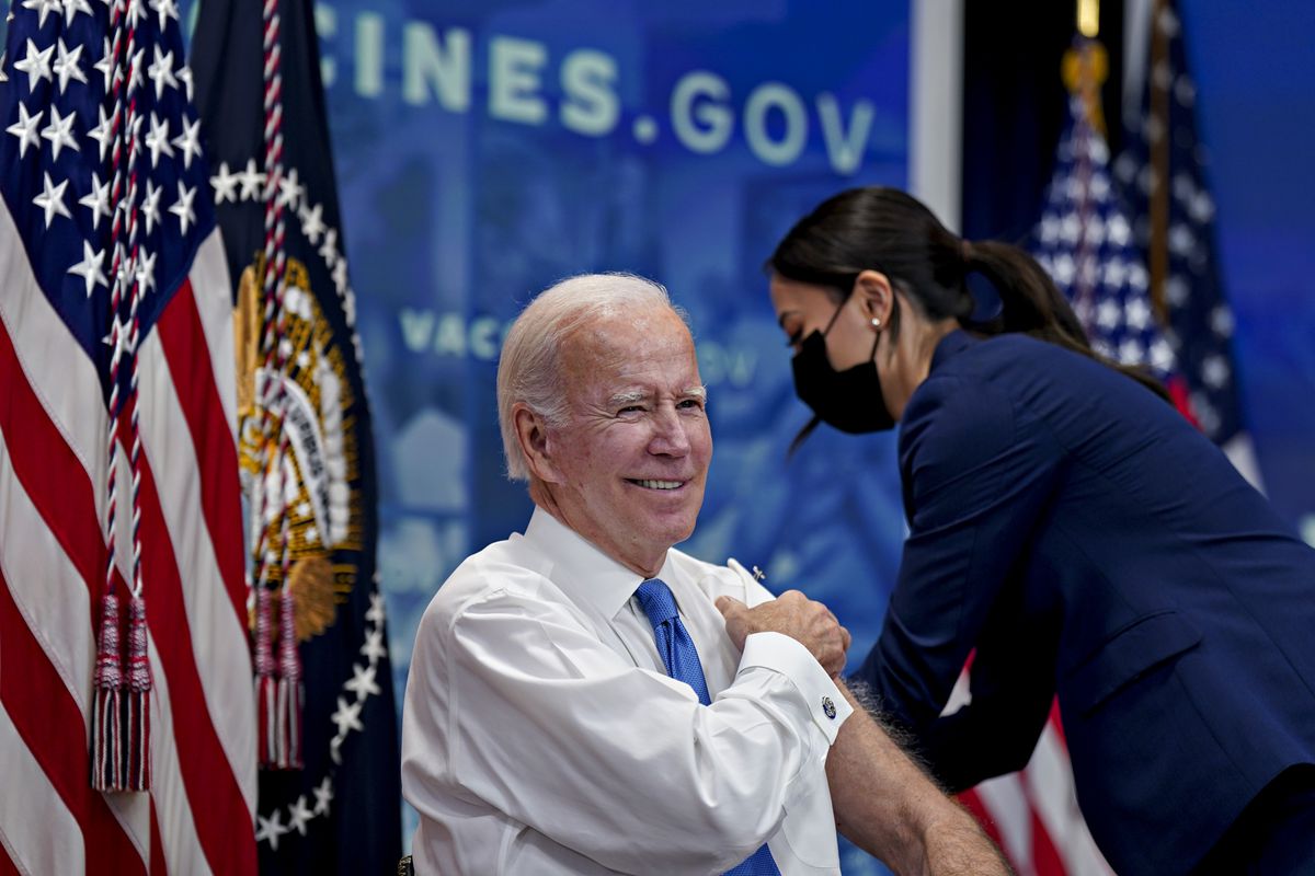 US President Joe Biden smiles before receiving a booster dose of the Covid-19 vaccine targeting the omicron BA.4/BA.5 subvariants in the Eisenhower Executive Office Building in Washington, DC, on October 25, 2022.