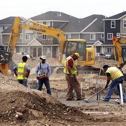 FILE "” Workers build housing in Vineyard, Tuesday, June 7, 2016. According to estimates released Tuesday, Utah's population increased 2.03 percent from July 2015 to July 2016, surpassing the 3 million mark.