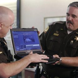 Utah Highway Patrol troopers Josh Carr and Lee Perry show dash camera footage of a freeway baby delivery during a press conference at Brigham City Community Hospital in Brigham City Sunday, Feb. 1, 2015.