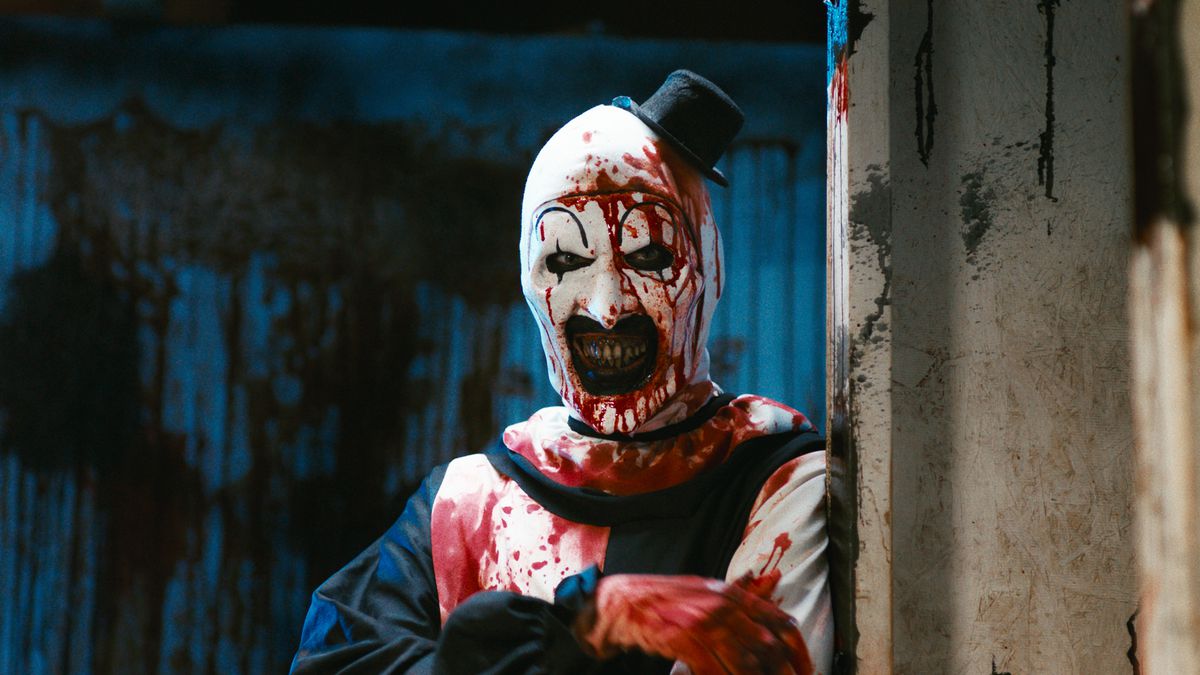 David Howard Thornton poses for a stock image facing the camera as Art the Clown, a blood-drenched, murderous mime in the horror film Terrifier 2