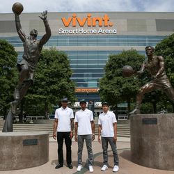 New Utah Jazz players Joel Bolomboy, Tyrone Wallace and Marcus Paige, left to right, pose for photos beside statues of Karl Malone and John Stockton during a tour of Vivint Smart Home Arena after a press event introducing the new players in Salt Lake City on Wednesday, June 29, 2016.