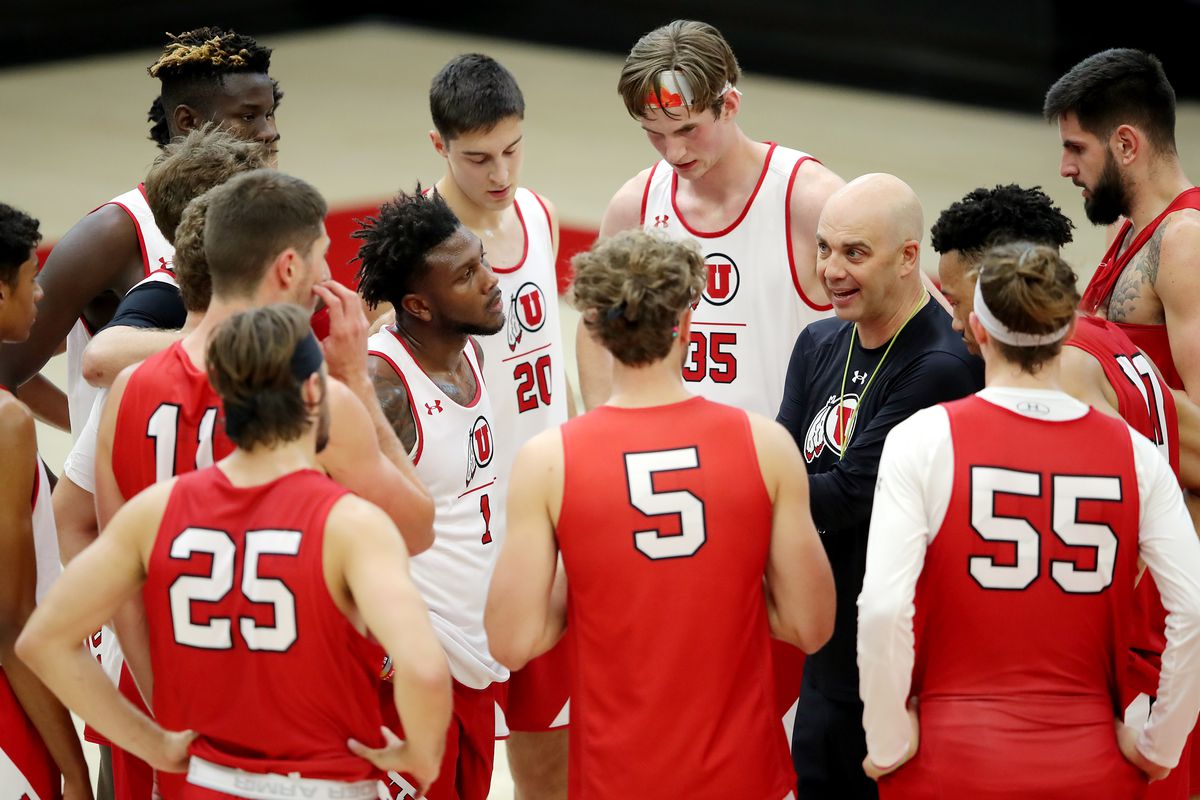 Utah basketball coach Craig Smith talks to his players in a team huddle as the team opens camp on Tuesday, Sept. 28, 2021.