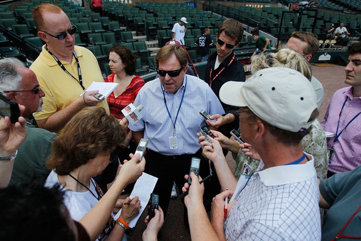 CHICAGO - JUNE 25: General manager Jim Hendry of the Chicago Cubs (center) talks to reporters before a game against the Chicago White Sox at U.S. Cellular Field on June 25, 2010 in Chicago, Illinois. (Photo by Jonathan Daniel/Getty Images)
