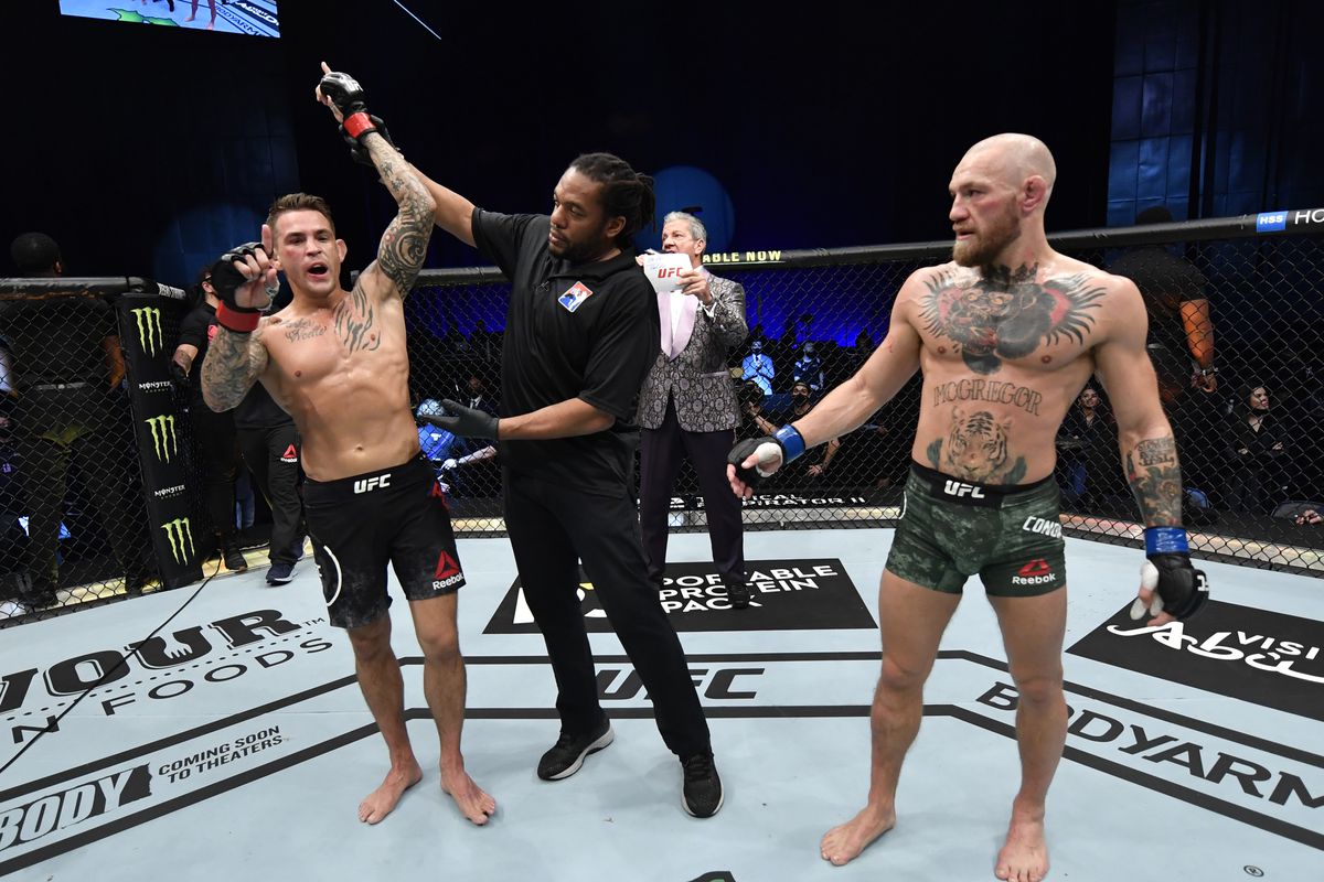Dustin Poirier gets his hand raised after beating Conor McGregor at UFC 257.