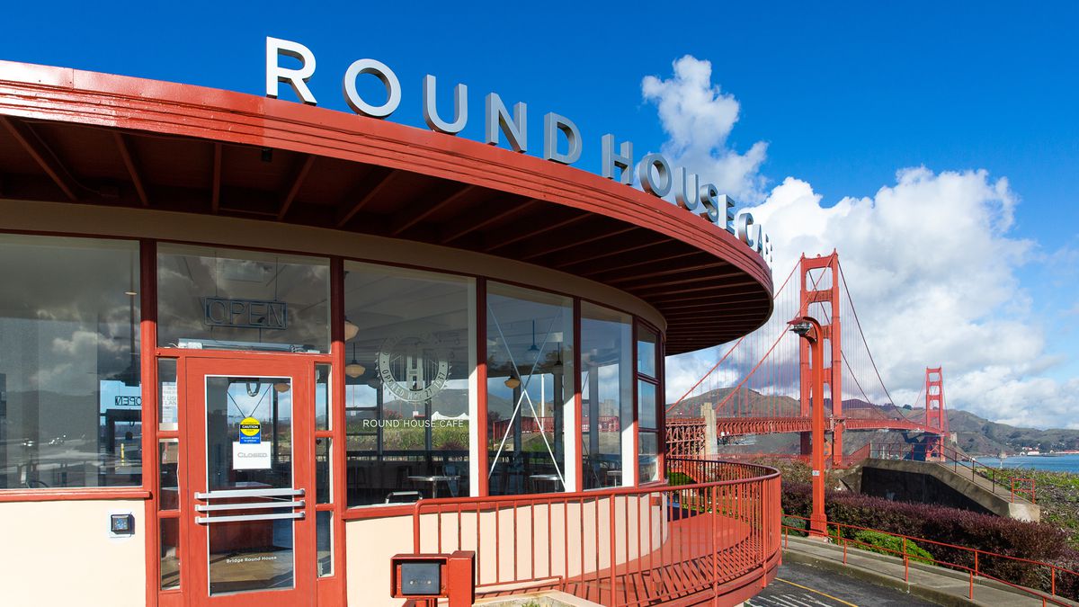 The exterior of Equator Coffees at Round House Cafe with the Golden Gate Bridge in the background