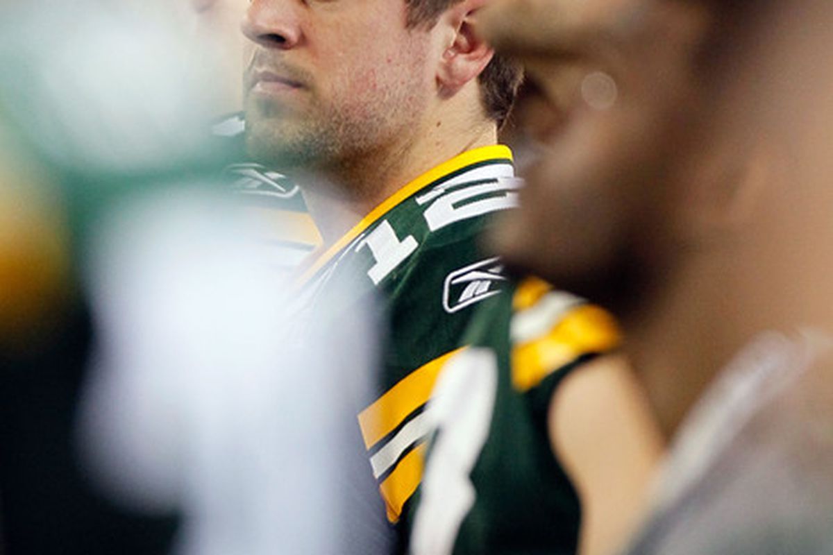 ARLINGTON TX - FEBRUARY 06: Aaron Rodgers #12 of the Green Bay Packers looks on as Christina Aguilera botches the National Anthem prior to Super Bowl XLV at Cowboys Stadium on February 6 2011 in Arlington Texas.  (Photo by Kevin C. Cox/Getty Images)