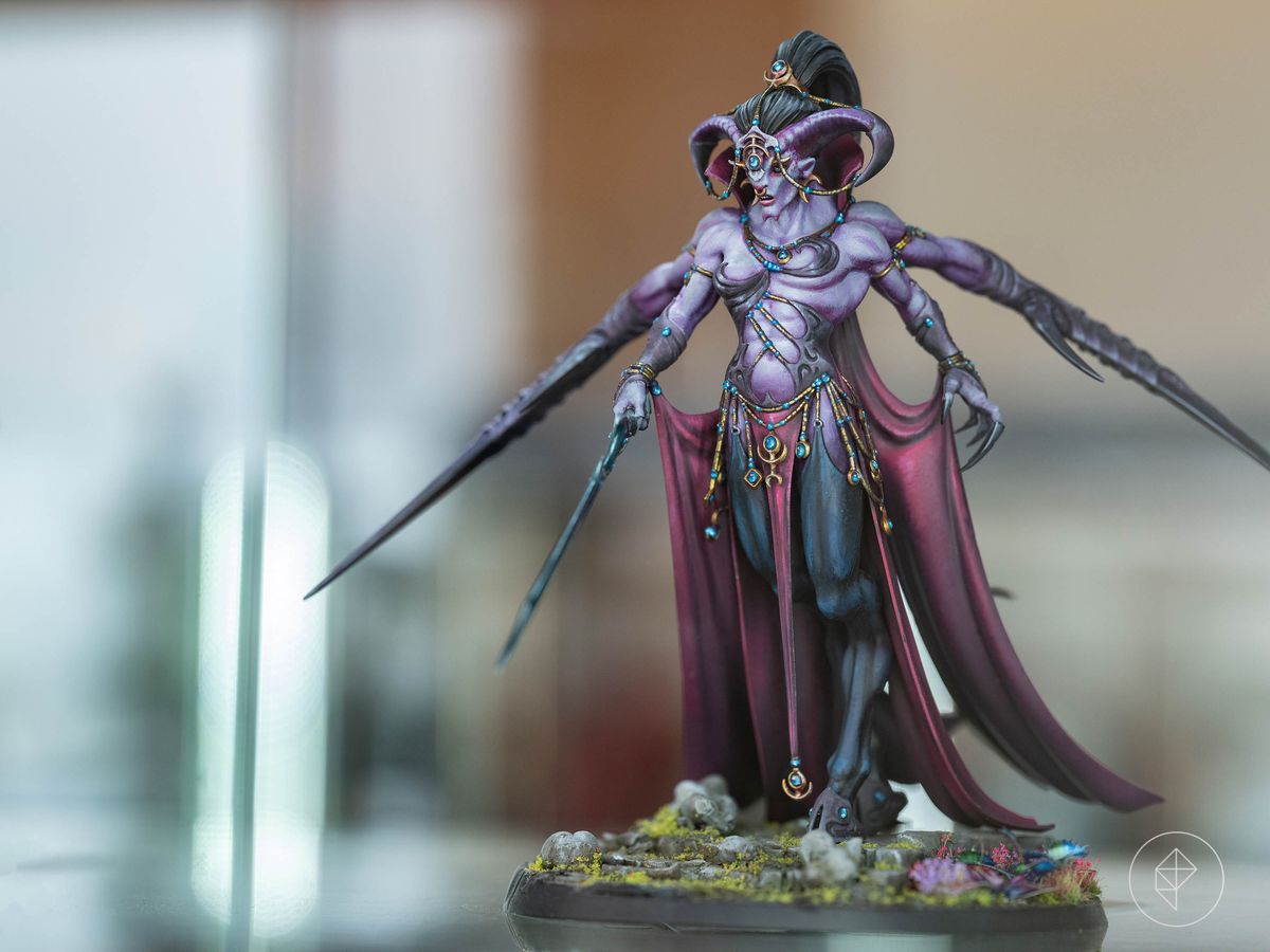 A four-armed demon in purple, from AdeptiCon 2023’s Golden Demon contest. It’s notable for the sculptural highlights on its major muscle groups. It’s legs are also clad in sheer cloth, which has an entirely different, more lustrous texture than its bare torso.
