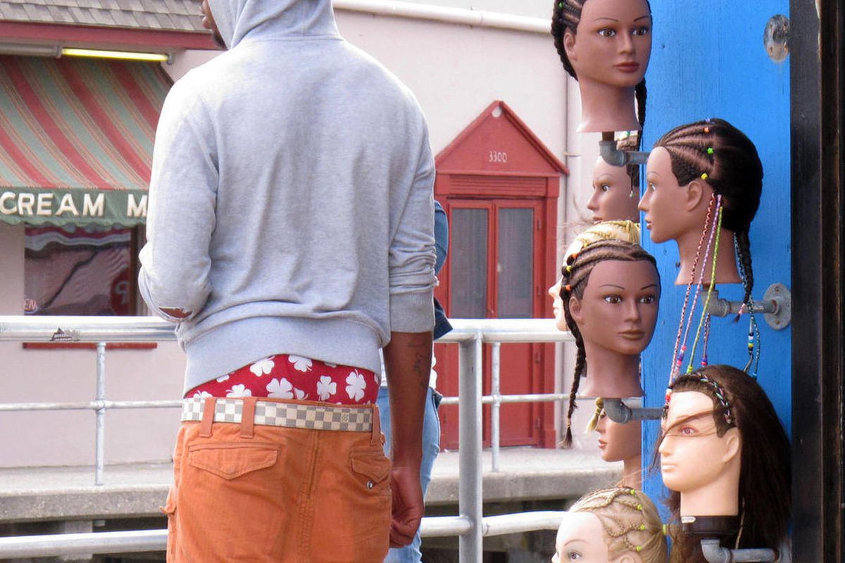 In a June 6, 2013 photo, a young man wears saggy pants on the Wildwood, N.J. boardwalk. Wildwood is set to pass a law Wednesday, June 12, 2013 regulating how people dress on its boardwalk, including a prohibition on pants that sag more than 3 inches below