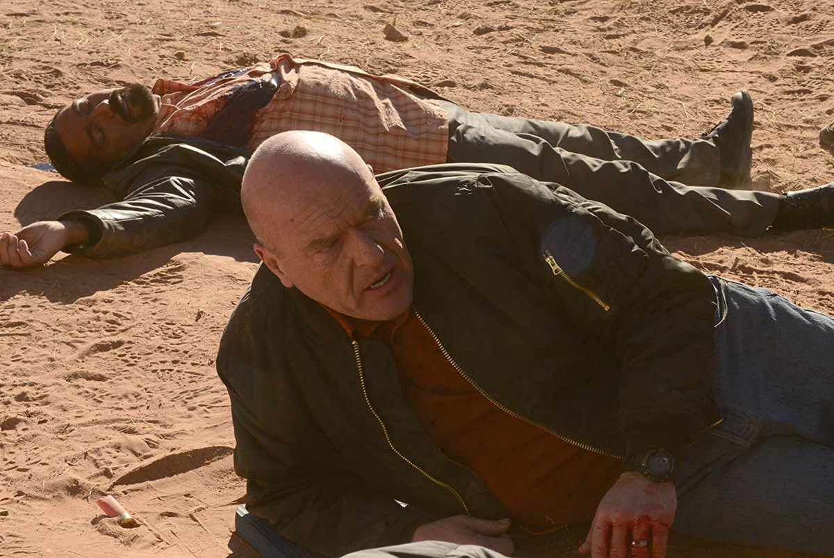 Dean Norris as Hank Schrader lying on the ground in the desert. 