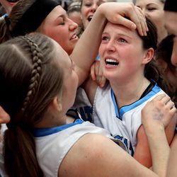 Sky View's Berkley Hellstern, center, celebrates with the team after winning the 4A championship game against Skyline at Salt Lake Community College Saturday, Feb. 21, 2015. The Bobcats beat the Eagles, 43-32.