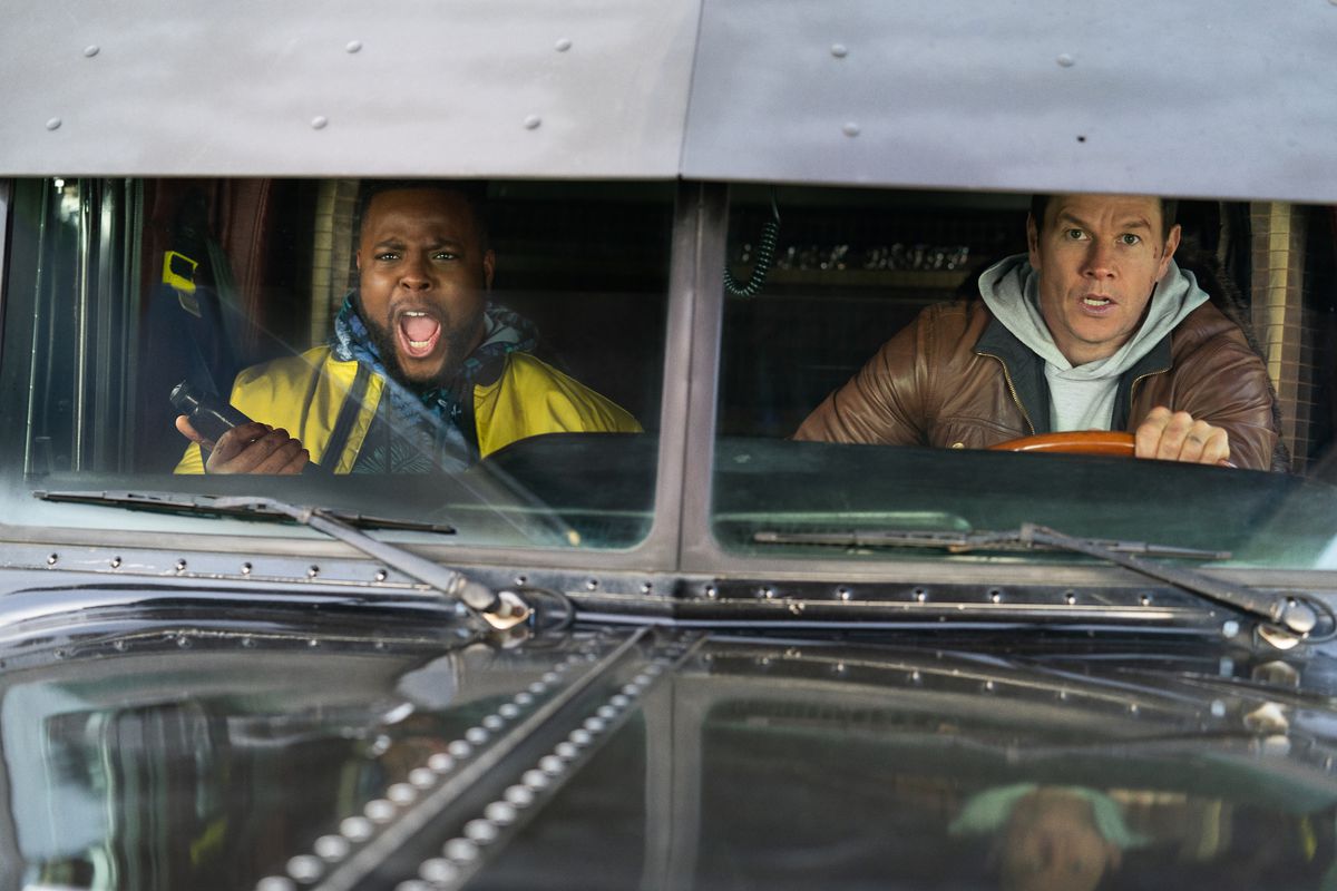 Wahlberg drives a truck as Duke, in the passenger seat, yells.