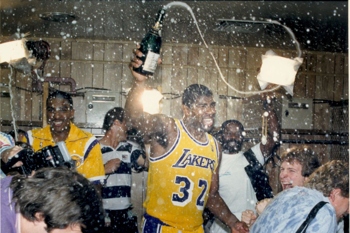 Lakers Magic Johnson celebrates in the locker room in 1987 after defeating the Boston Celtics to win