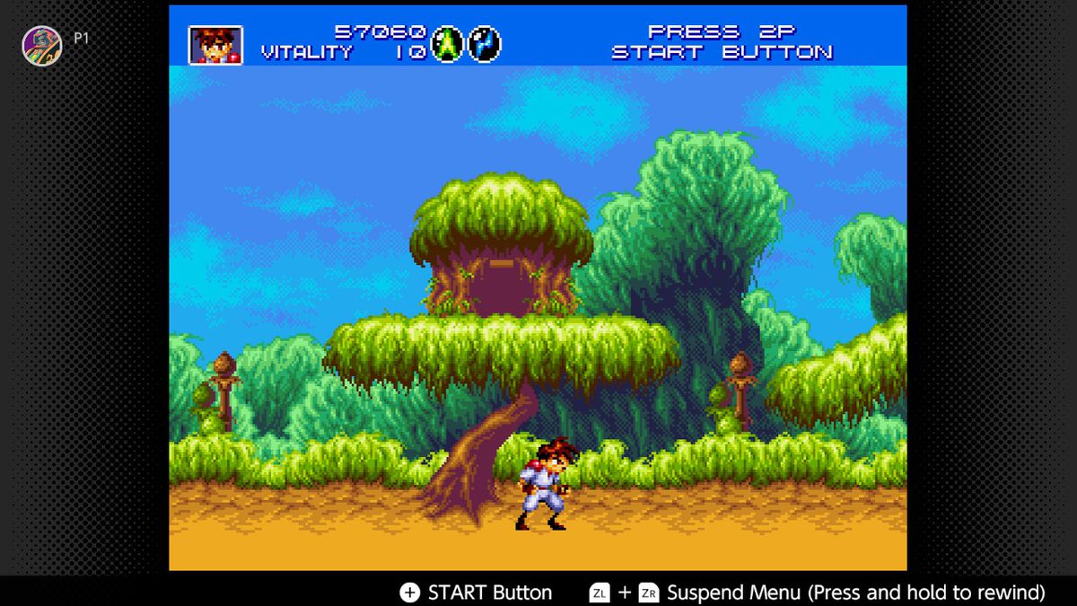 The hero runs through the environment and under a treehouse in Gunstar Heroes