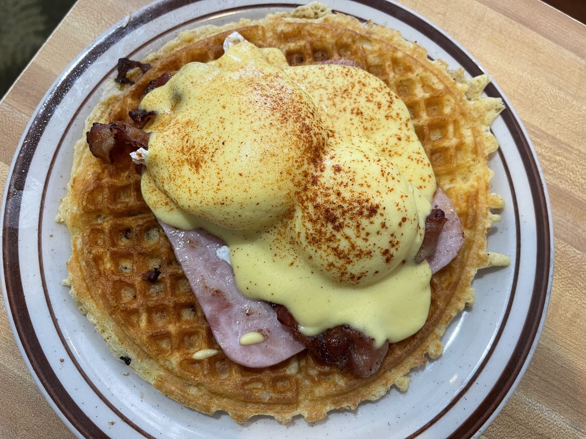 B.W. Benny - waffle with bacon morsels, topped with bacon, ham, and two poached eggs with hollandaise sauce