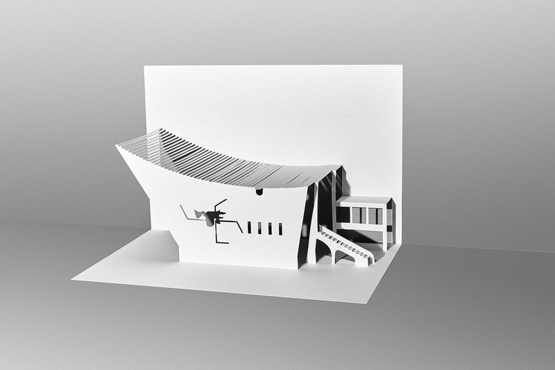 Paper cutout model of a building with curved roofline. 