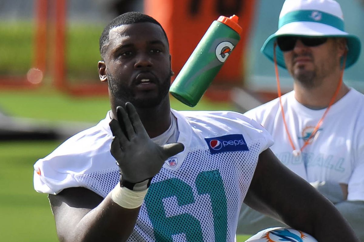 Miami Dolphins offense linemen Donald Hawkins (61) takes a drink during practice drills at Doctors Hospital Training Facility.