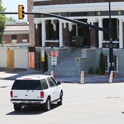 A Ford Expedition and a bicyclist make a left-hand turn in Salt Lake City on Monday, June 25, 2018.