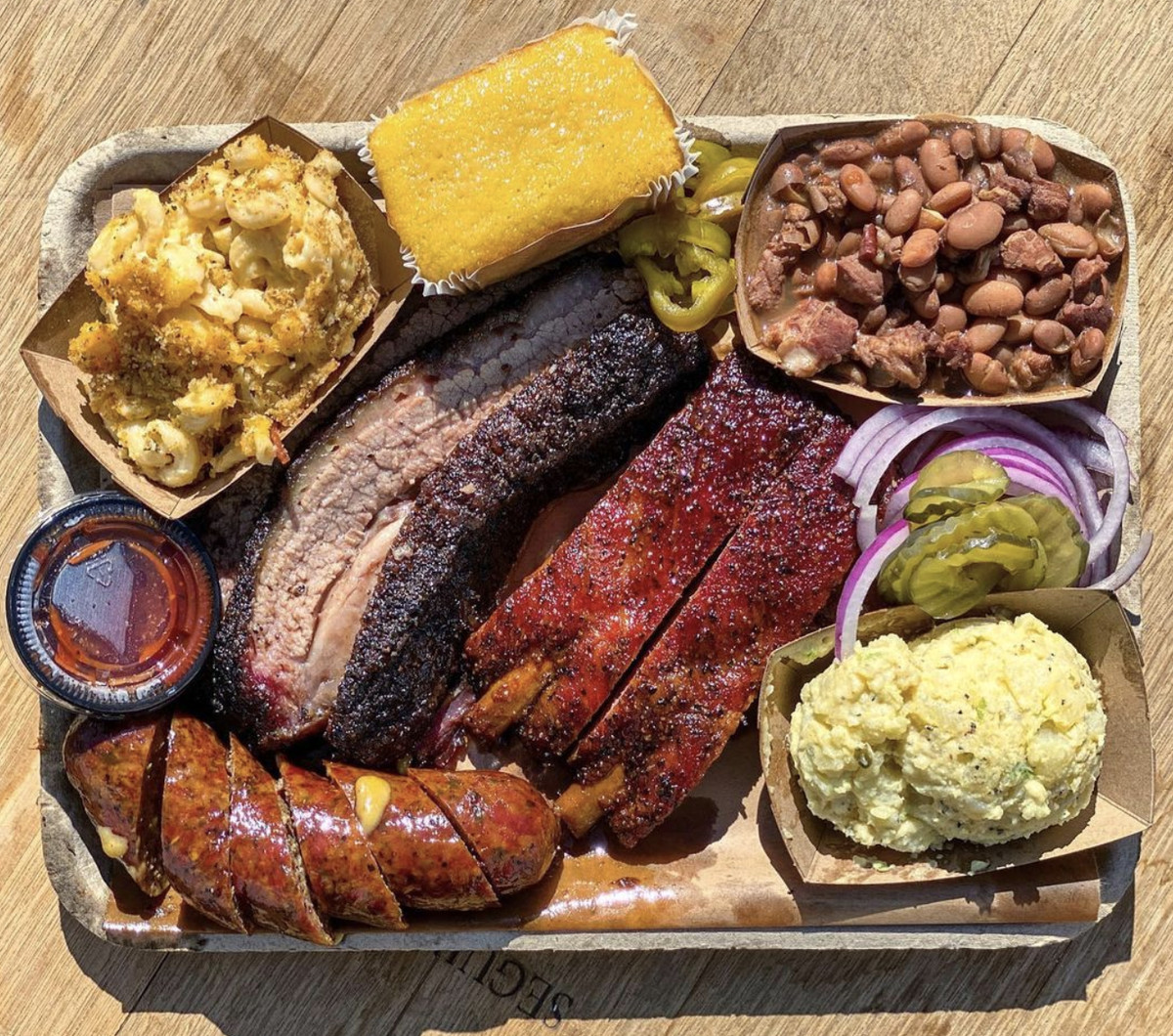 Plate of barbecue from Herc’s on a tray with sides.