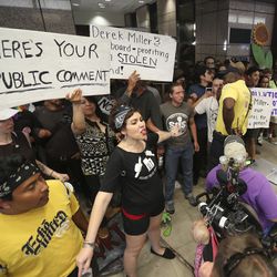 Protesters block the path of a security guard at the Chamber of Commerce Building at 175 E. 400 South in Salt Lake City on Tuesday, July 9, 2019. The protest over the Utah Inland Port began at the City-County Building and moved to the Chamber of Commerce Building where the port authority meets.