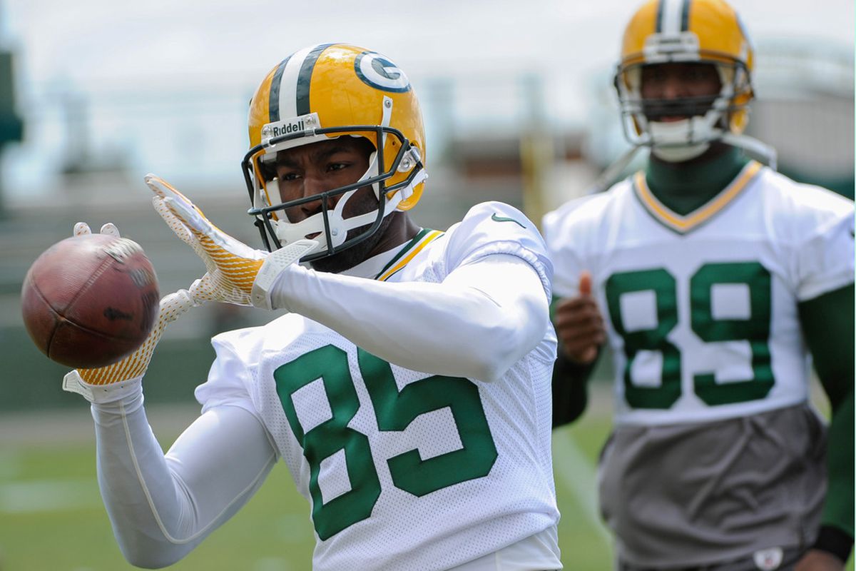June 12, 2012; Green Bay, WI, USA;   Green Bay Packers wide receiver Greg Jennings (85) catches a ball during the team's mandatory minicamp at Ray Nitschke Field.  Mandatory Credit: Benny Sieu-US PRESSWIRE