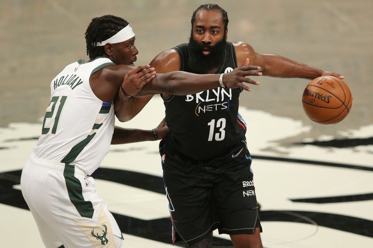 Brooklyn Nets shooting guard James Harden (13) controls the ball against Milwaukee Bucks point guard Jrue Holiday (21) during the third quarter of game five of the second round of the 2021 NBA Playoffs at Barclays Center.